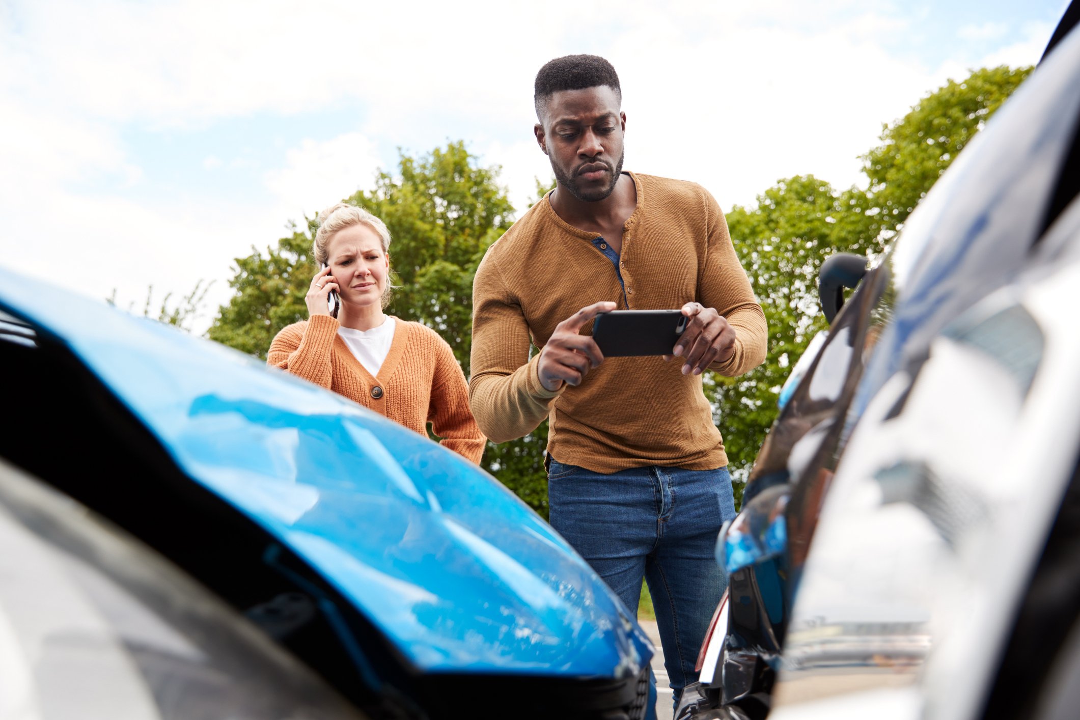 Two drivers examine a fender bender.