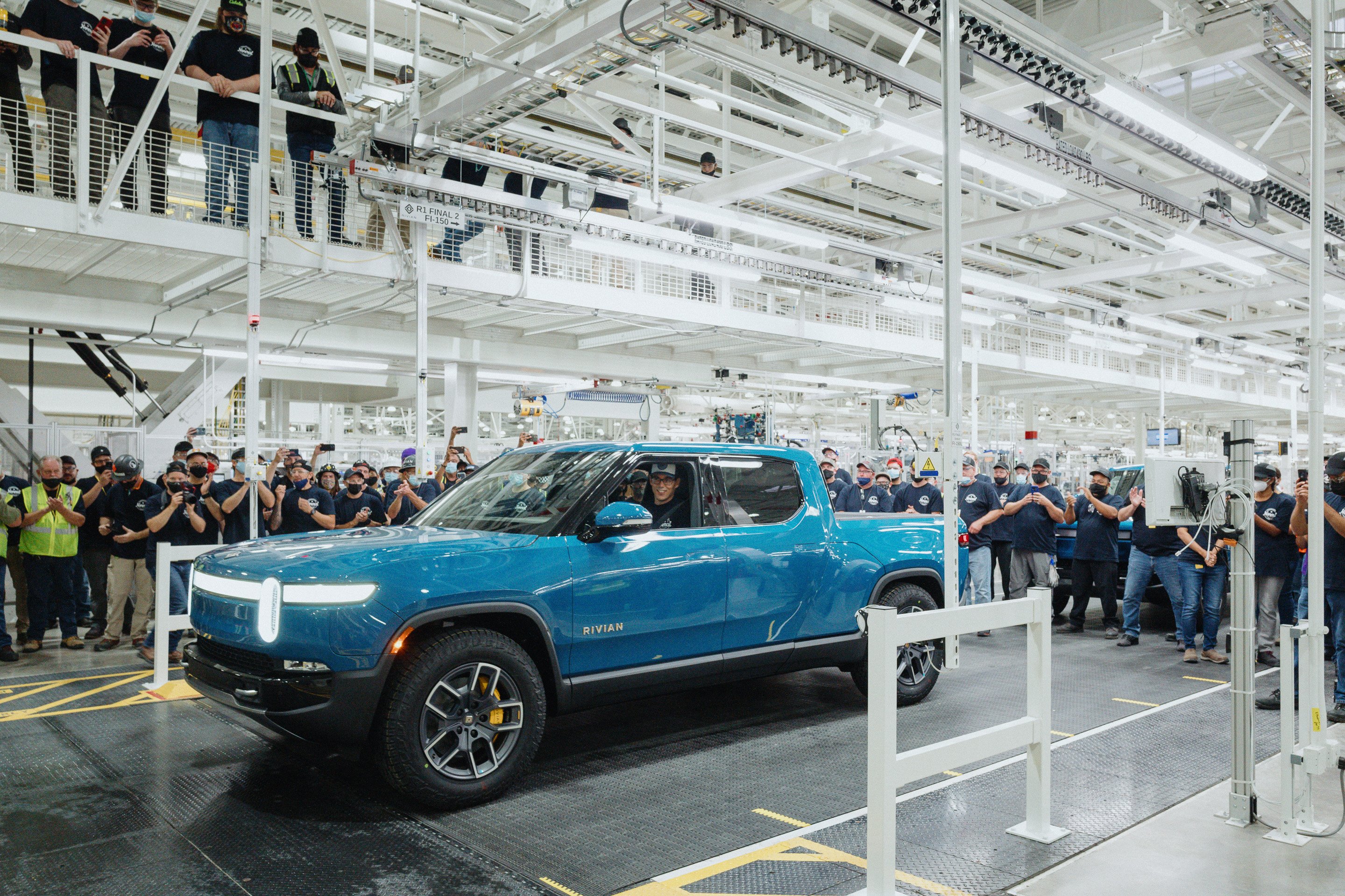 Rivian CEO RJ Scaringe in  first sky blue R1T pickup truck off production line in 2021.