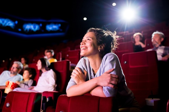 A group of people watching a movie in a movie theater.