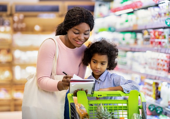 Two people smiling in grocery store.