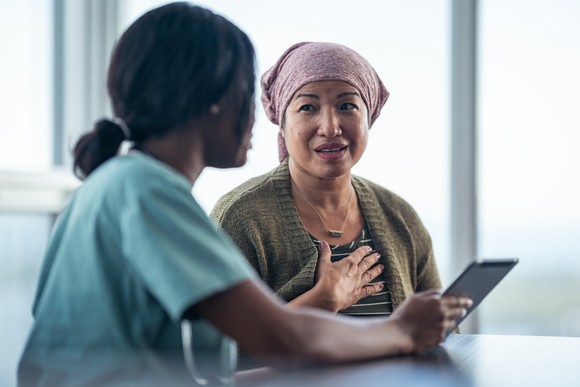A medical worker goes over information with a patient.