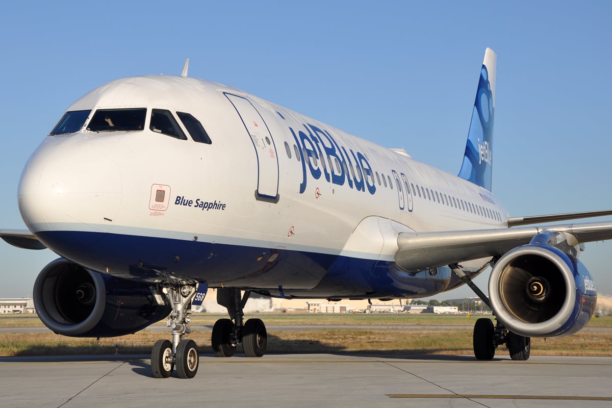 A JetBlue A320 parked on the tarmac. 