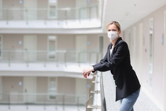 Person wearing mask inside apartment building.