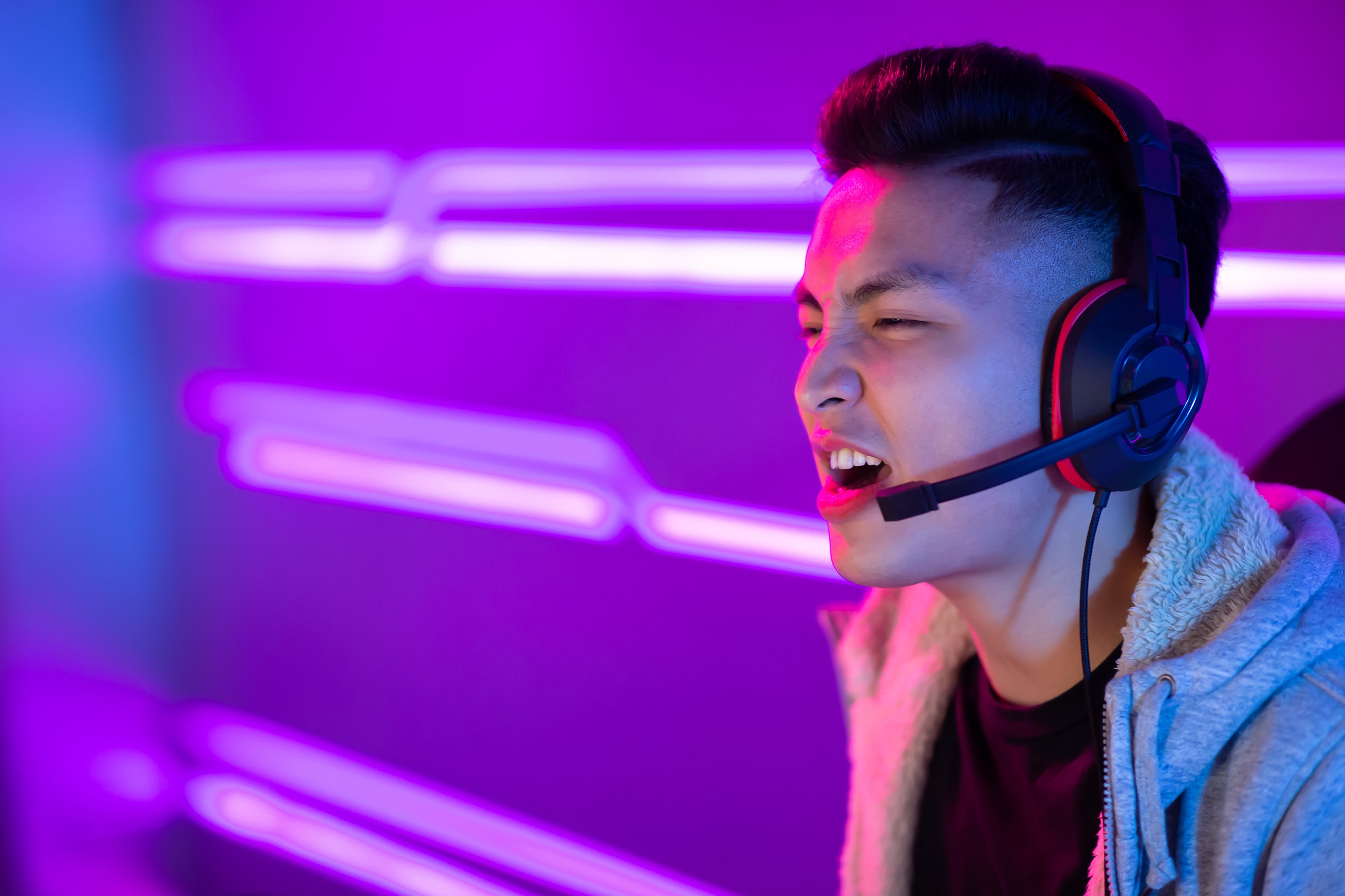 A person wearing a headset plays a video game.