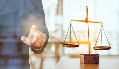 A scale and a person pointing.