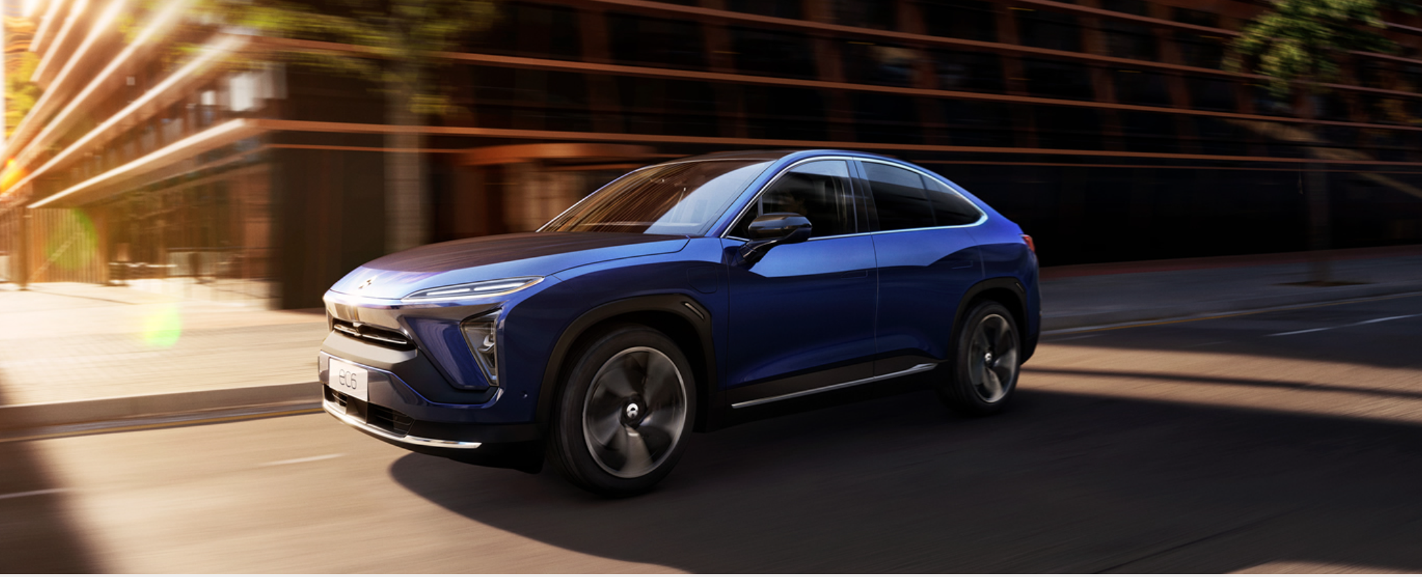 blue Nio EC6 electric vehicle on road. 