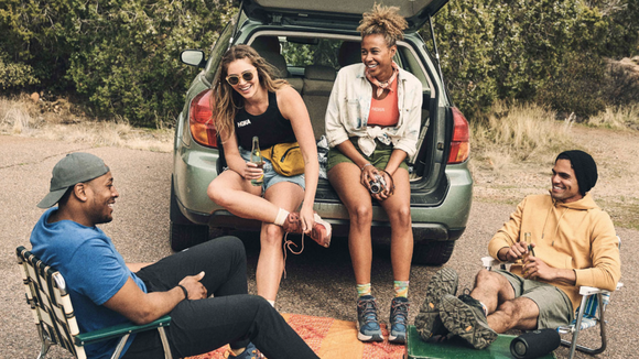 People are wearing comfortable clothes while relaxing outdoors. 