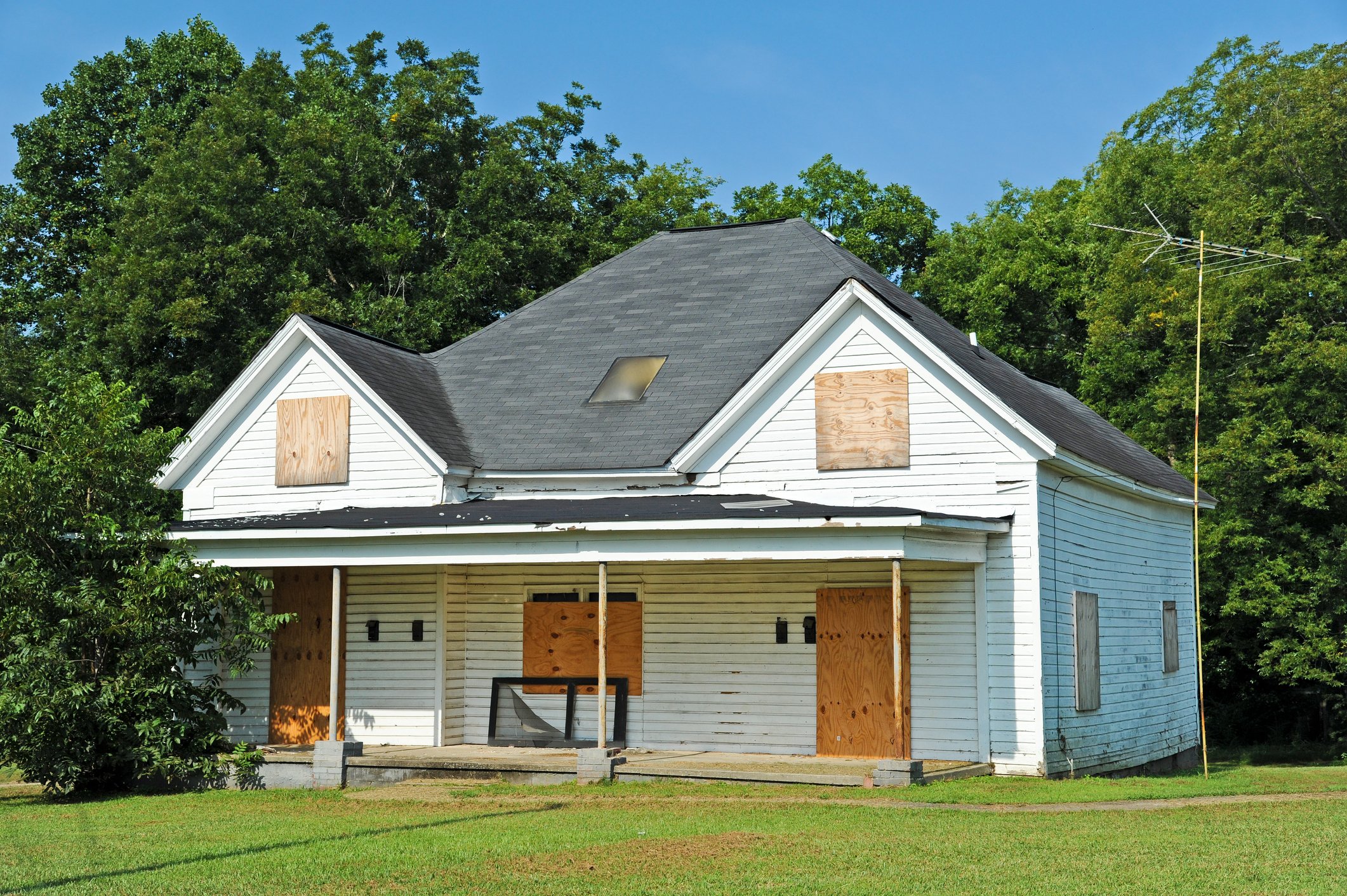 Boarded up single-family home sitting empty.