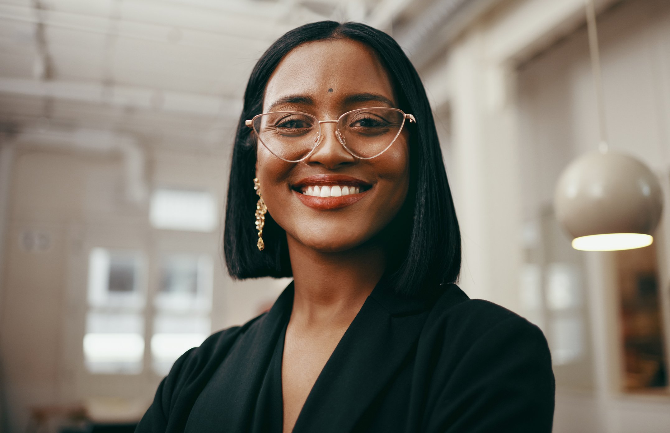 A young professional is smiling toward the camera.