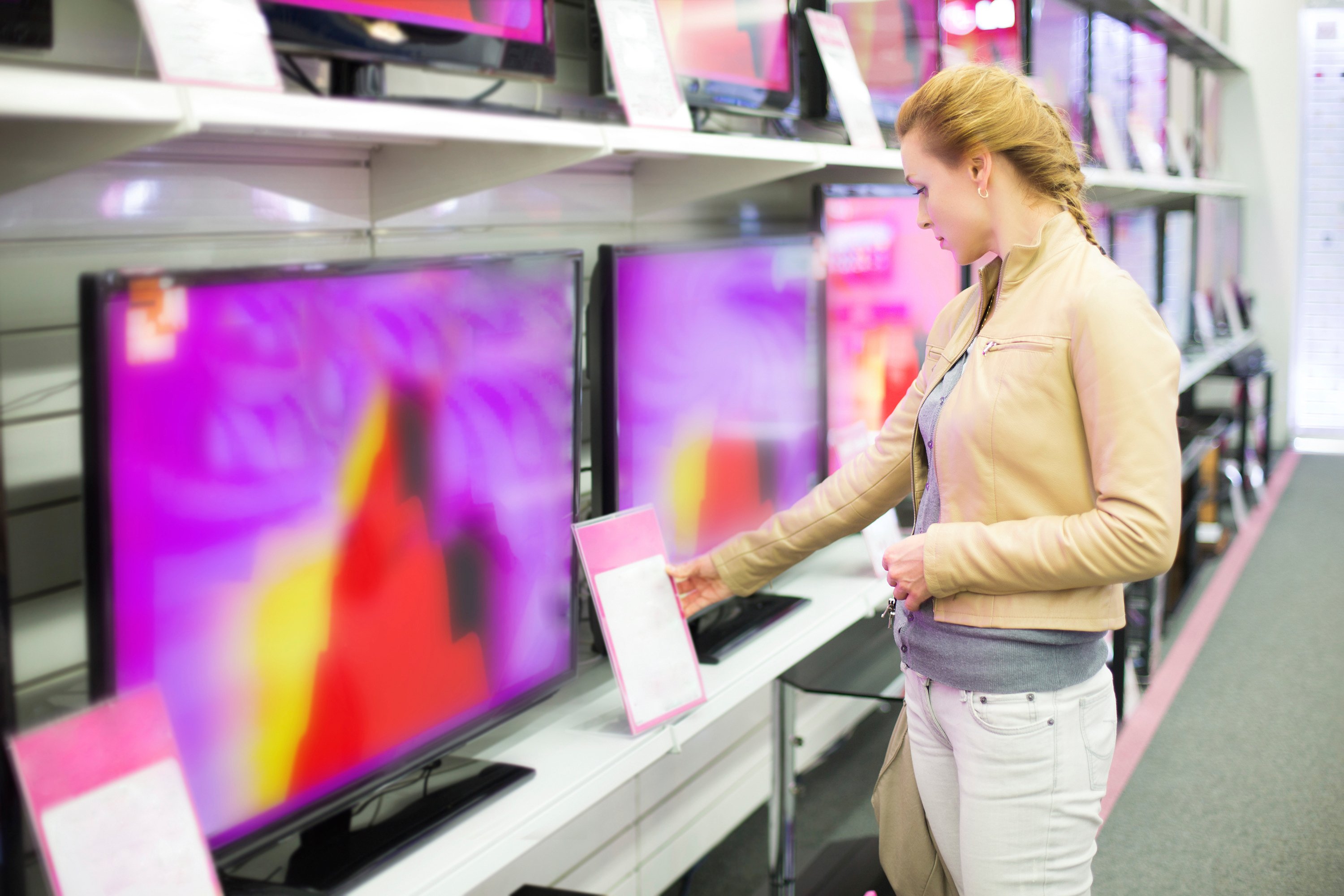 A woman shopping for a TV.
