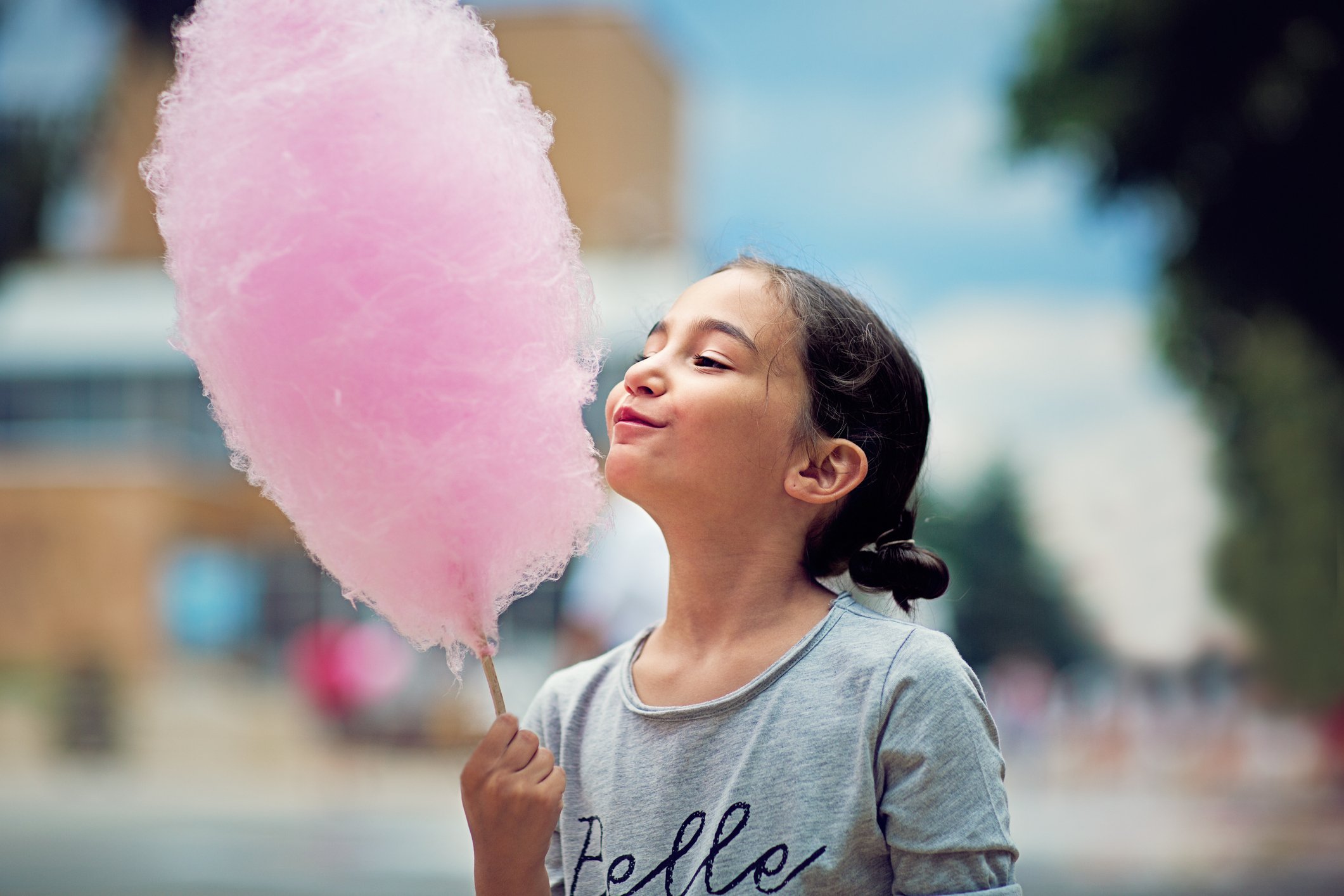 A child holding cotton candy.