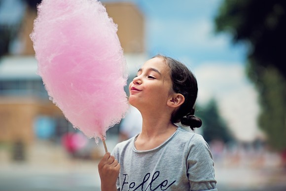 A child holding cotton candy.