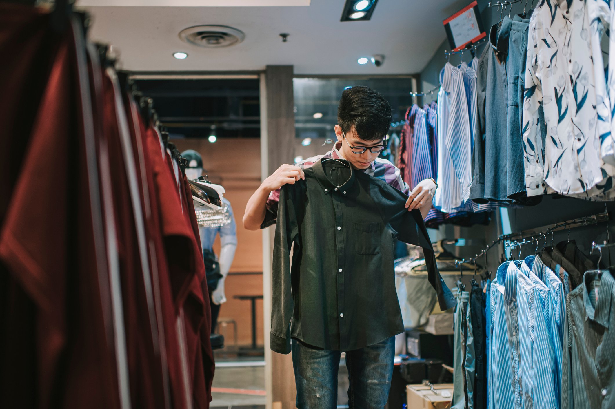A person is shopping in an apparel store. 