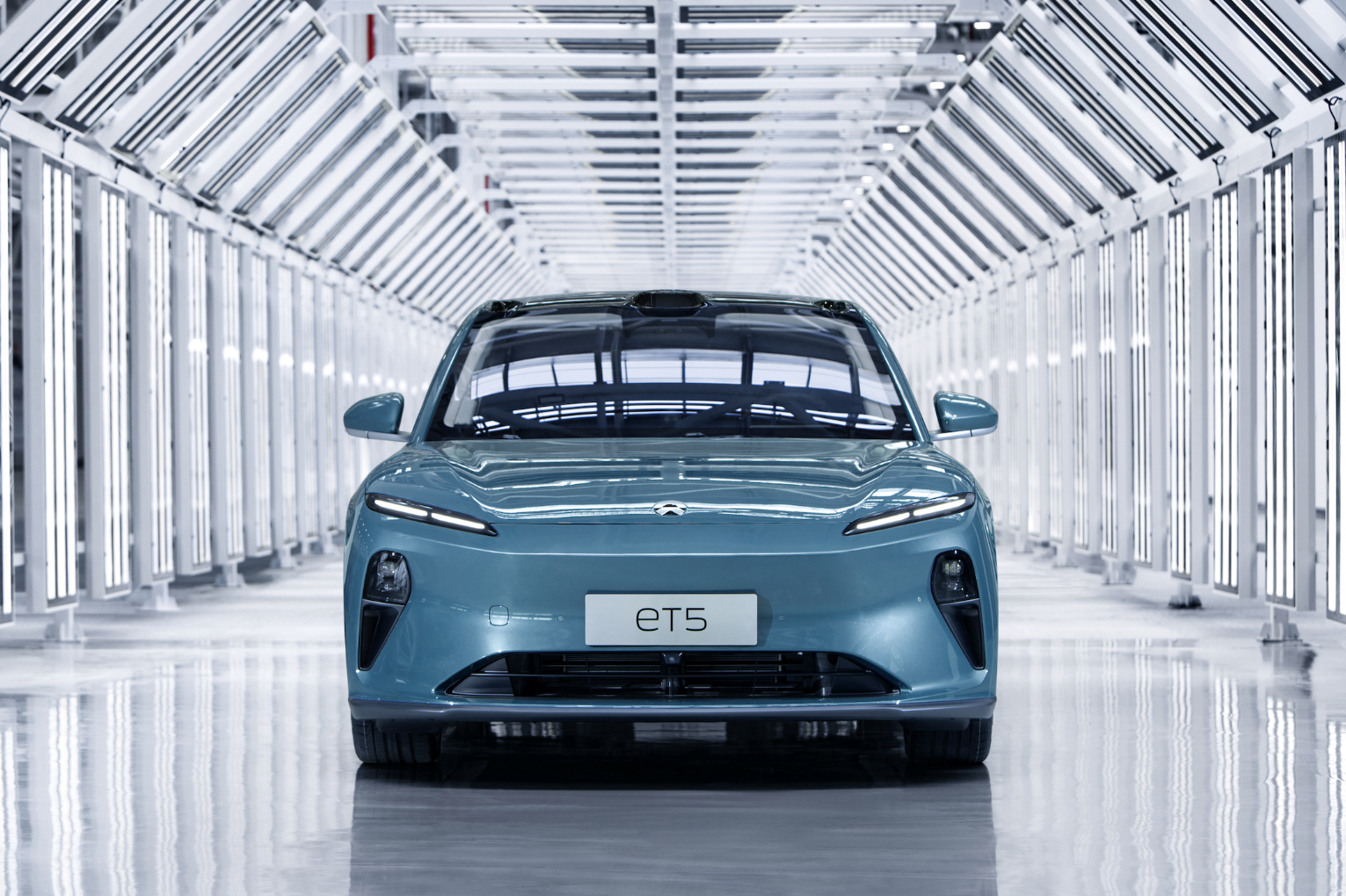 Front view of prototype sky blue Nio ET5 mid-size sedan.