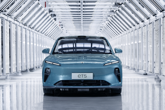 Front view of prototype sky blue Nio ET5 mid-size sedan.