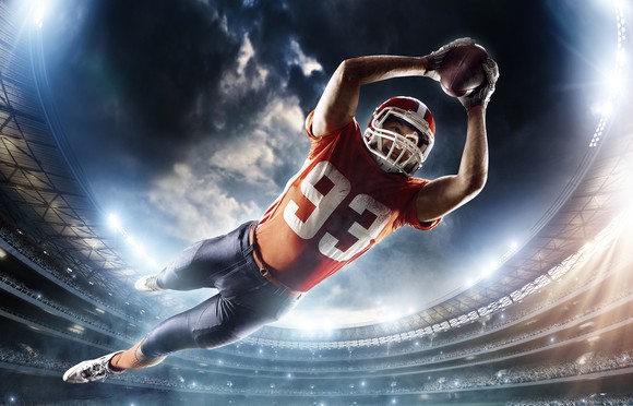 Football player leaping to make a touchdown.