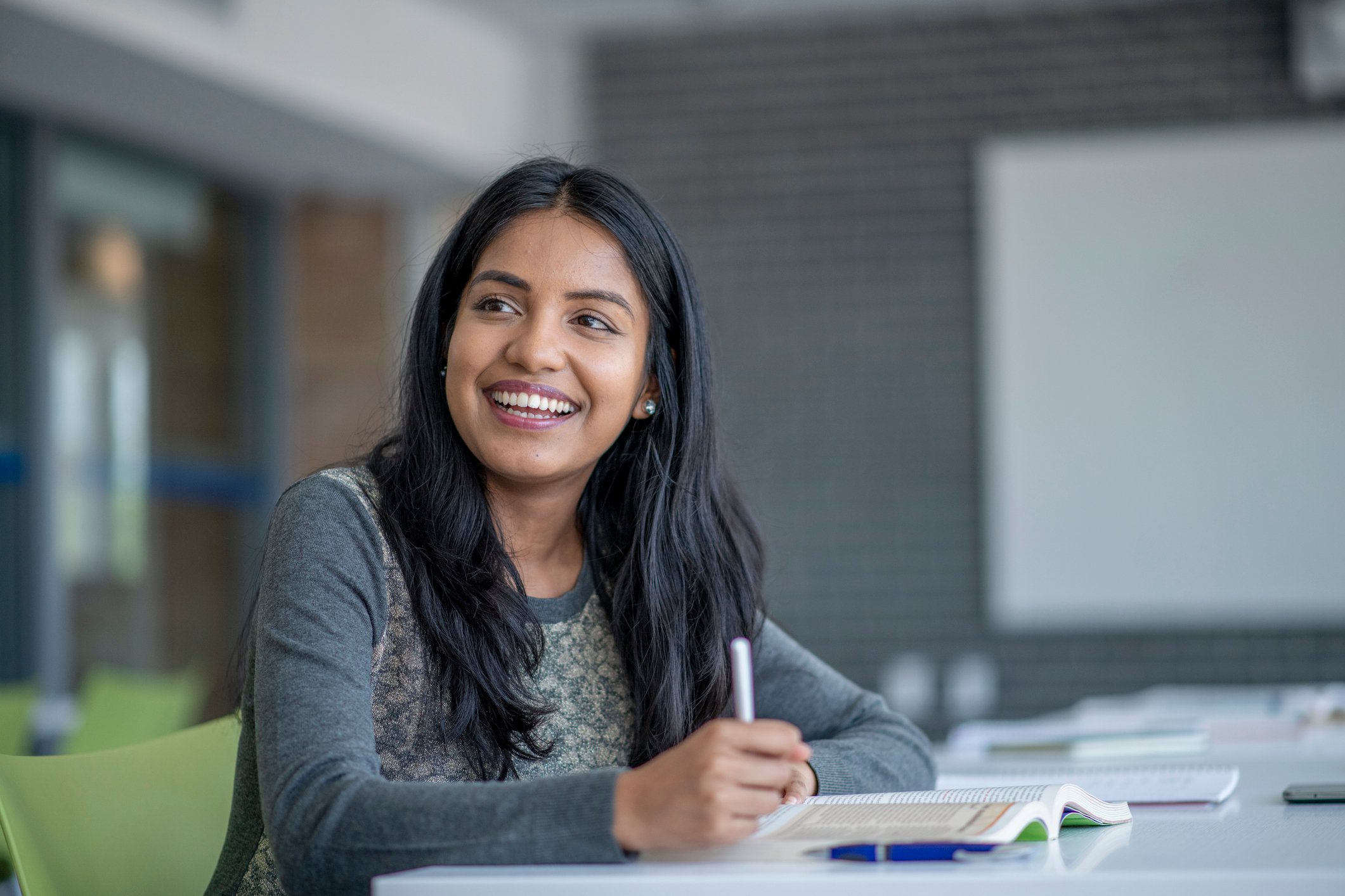 Person taking notes and smiling.