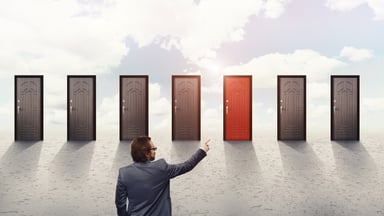 Doors with a man pointing to 1 of them