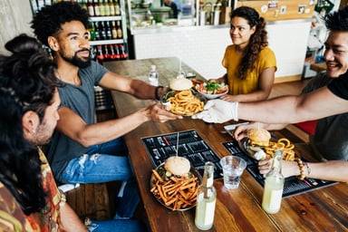 A group of people eating at a restaurant.
