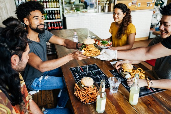 A group of people eating at a restaurant.