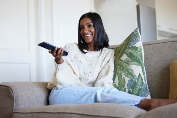 Person sitting on a couch watching television.