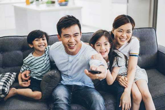 A family enjoying a television show.