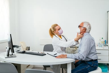 A doctor examines their patient at an appointment