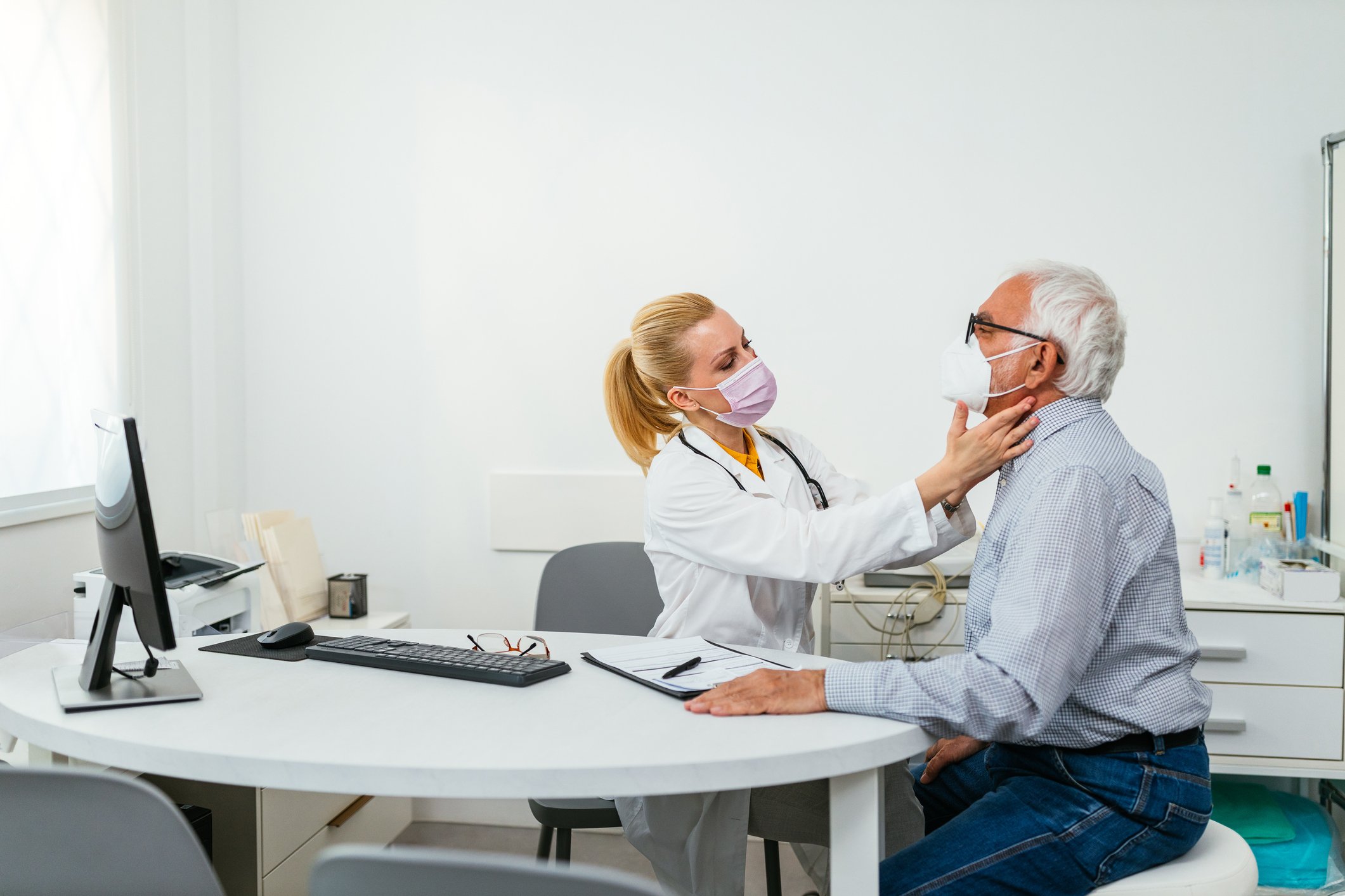 A doctor examines their patient at an appointment.