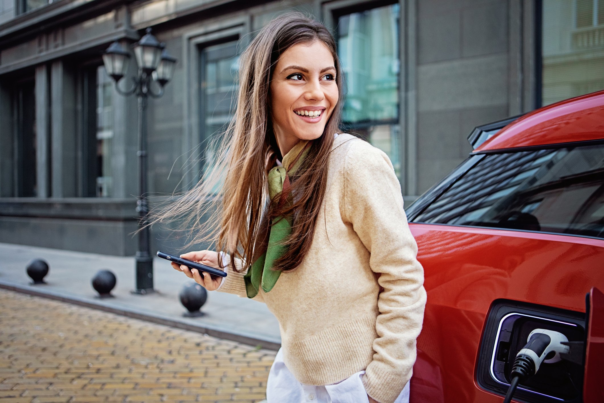 A driver outside an electric car.