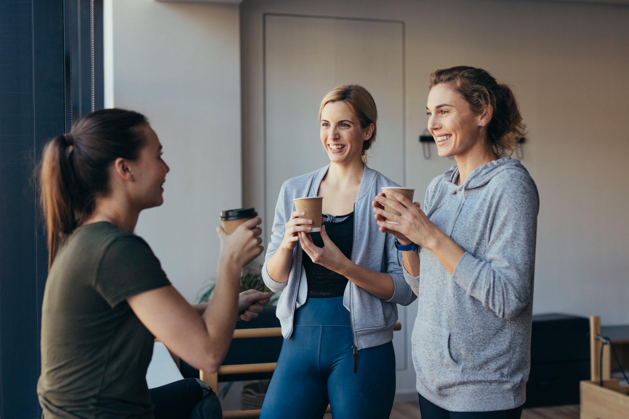 Three people drinking coffee.