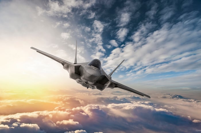 Fighter jet flying over the clouds.