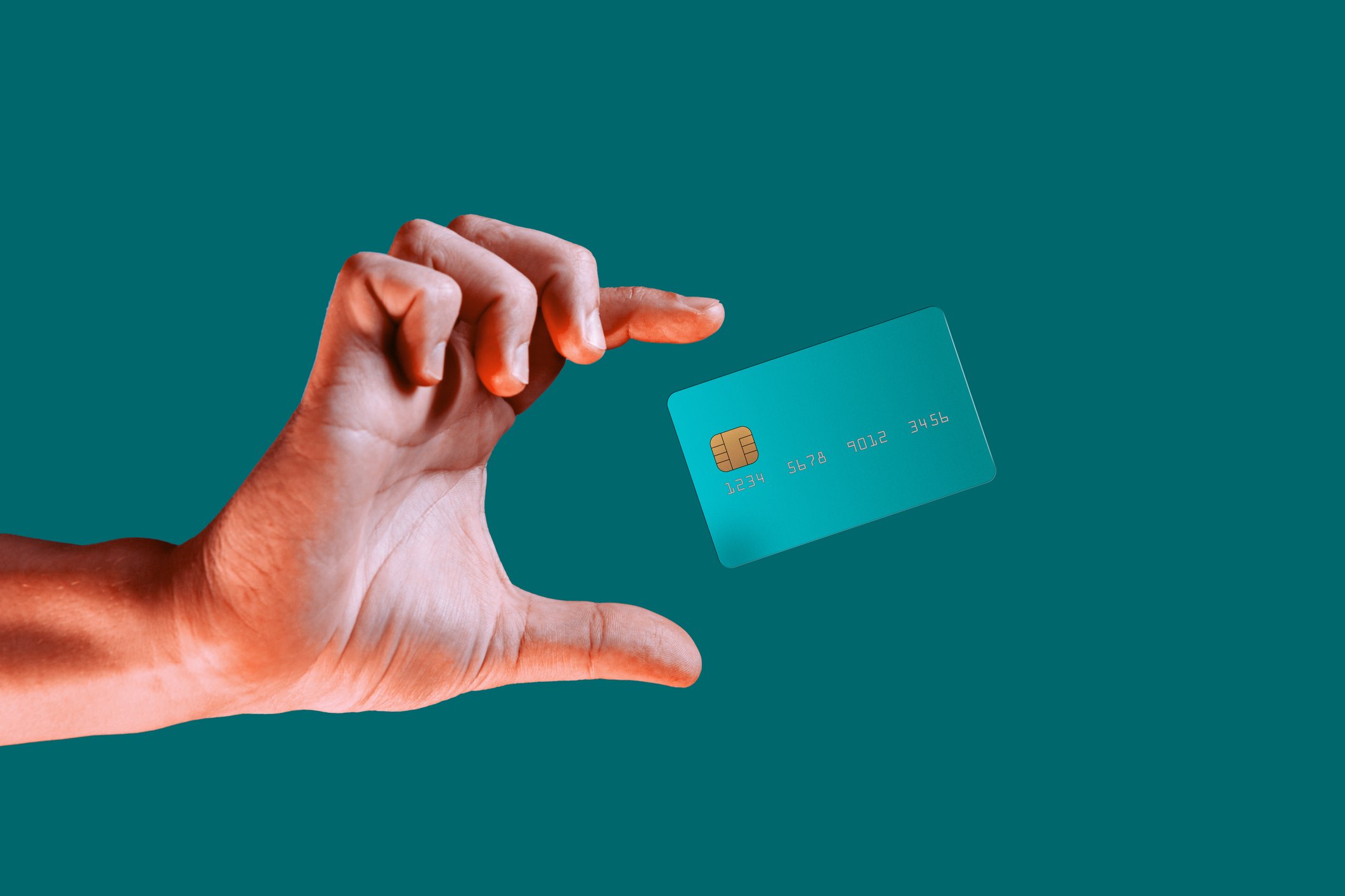 Person holding up a payment card.