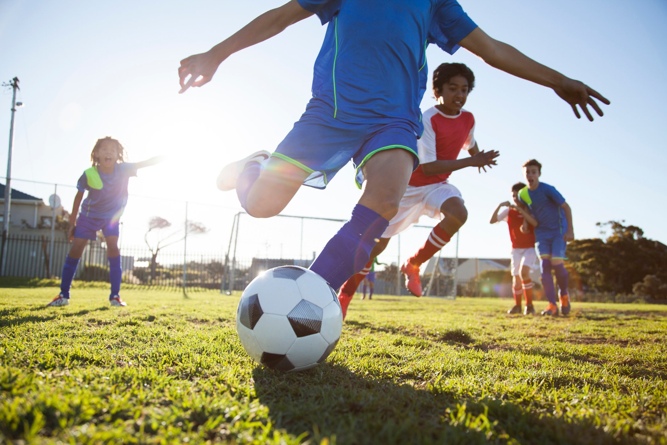 Children play soccer outdoors.