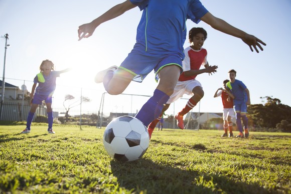 Children play soccer outdoors.