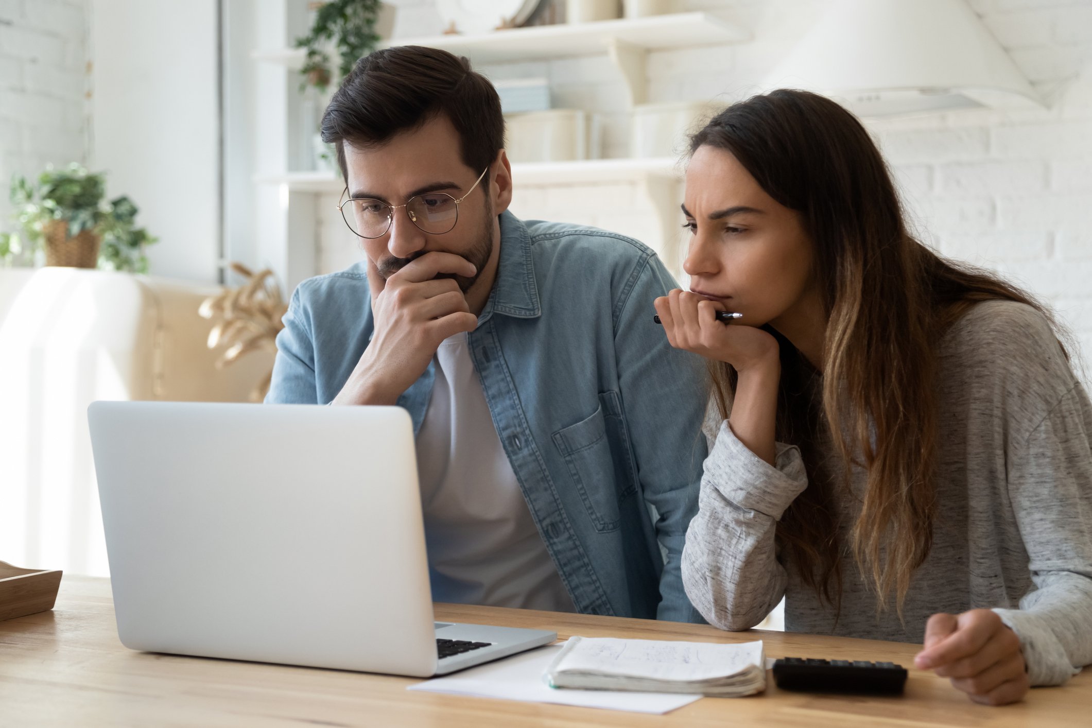 Two people looking at a laptop.