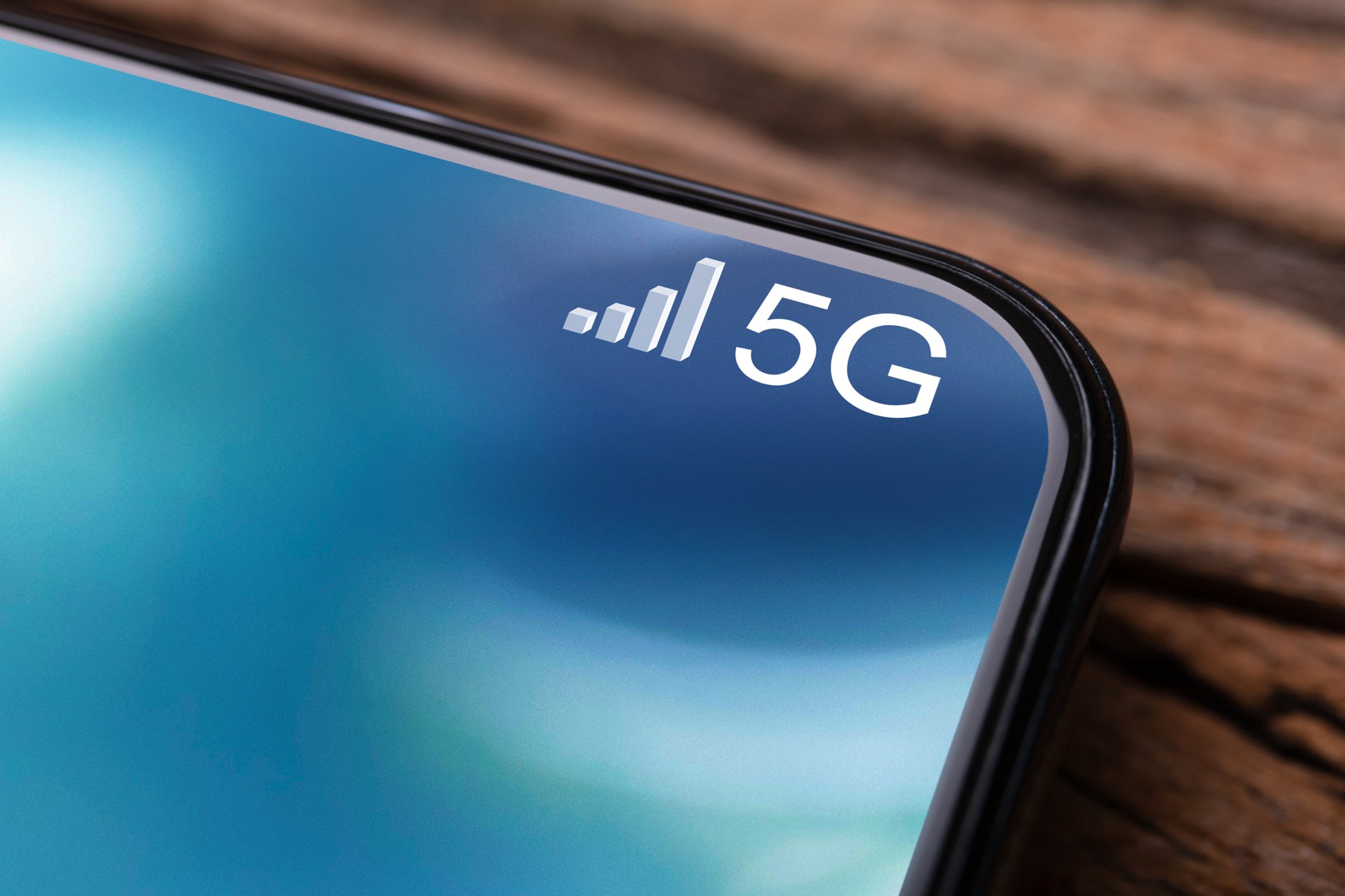 A close-up on the 5G icon in the corner of a smartphone screen.
