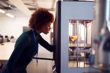 A woman uses a 3D printer