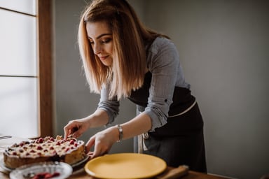 Baker slicing up a berry pie.