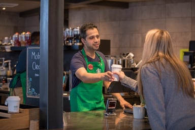 A Starbucks barista serving a customer