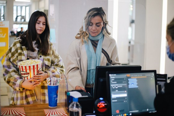 Two people purchasing concessions at a movie theater.