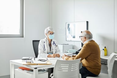 Doctor discussing with elderly man