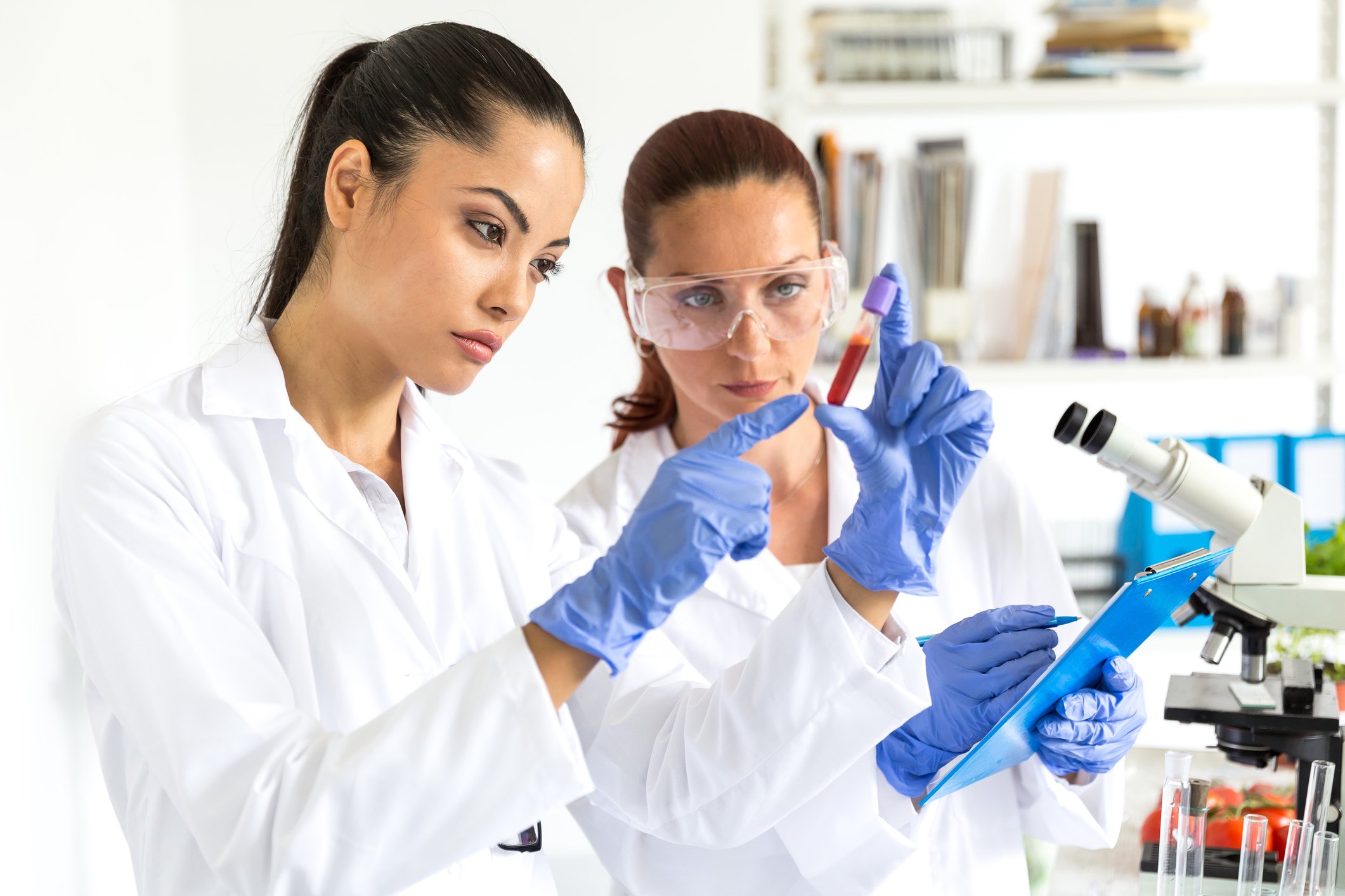 two biopharma techs studying samples in lab