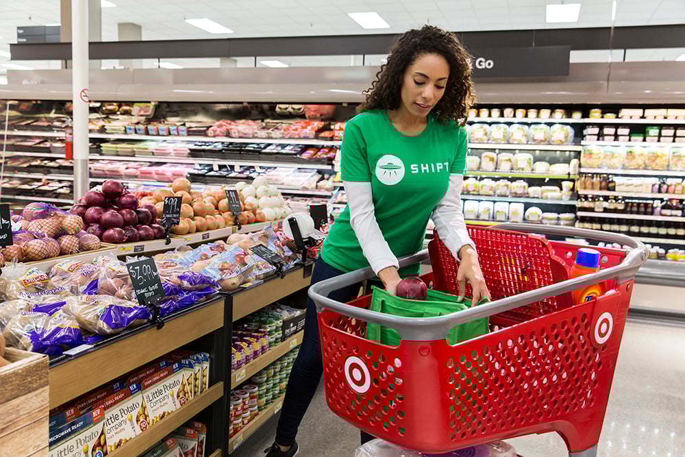 A Shipt shopper putting items in a cart at Target.