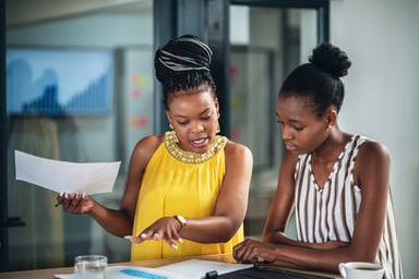 Two coworkers discussing a document