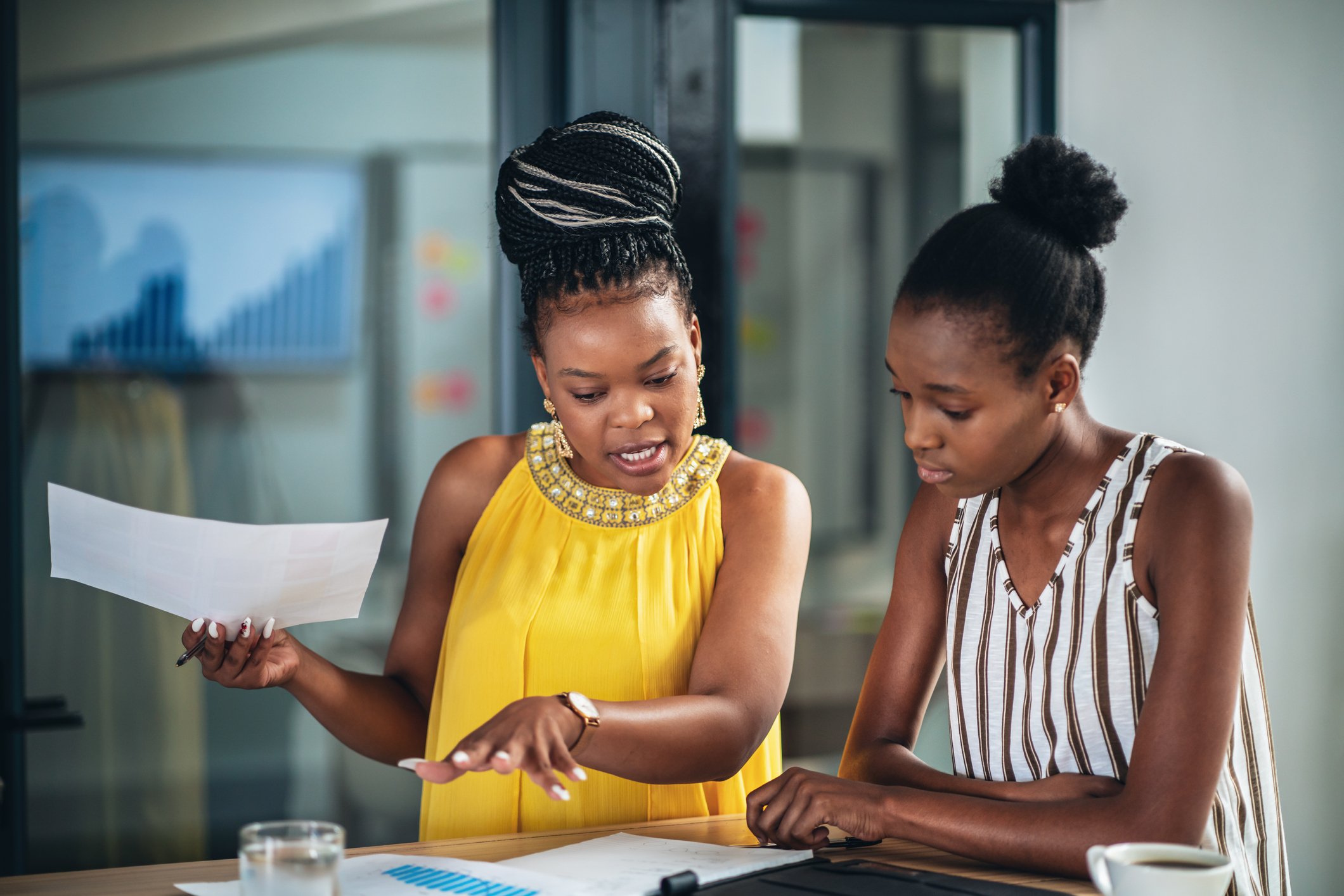 Two businesspeople discussing a document.