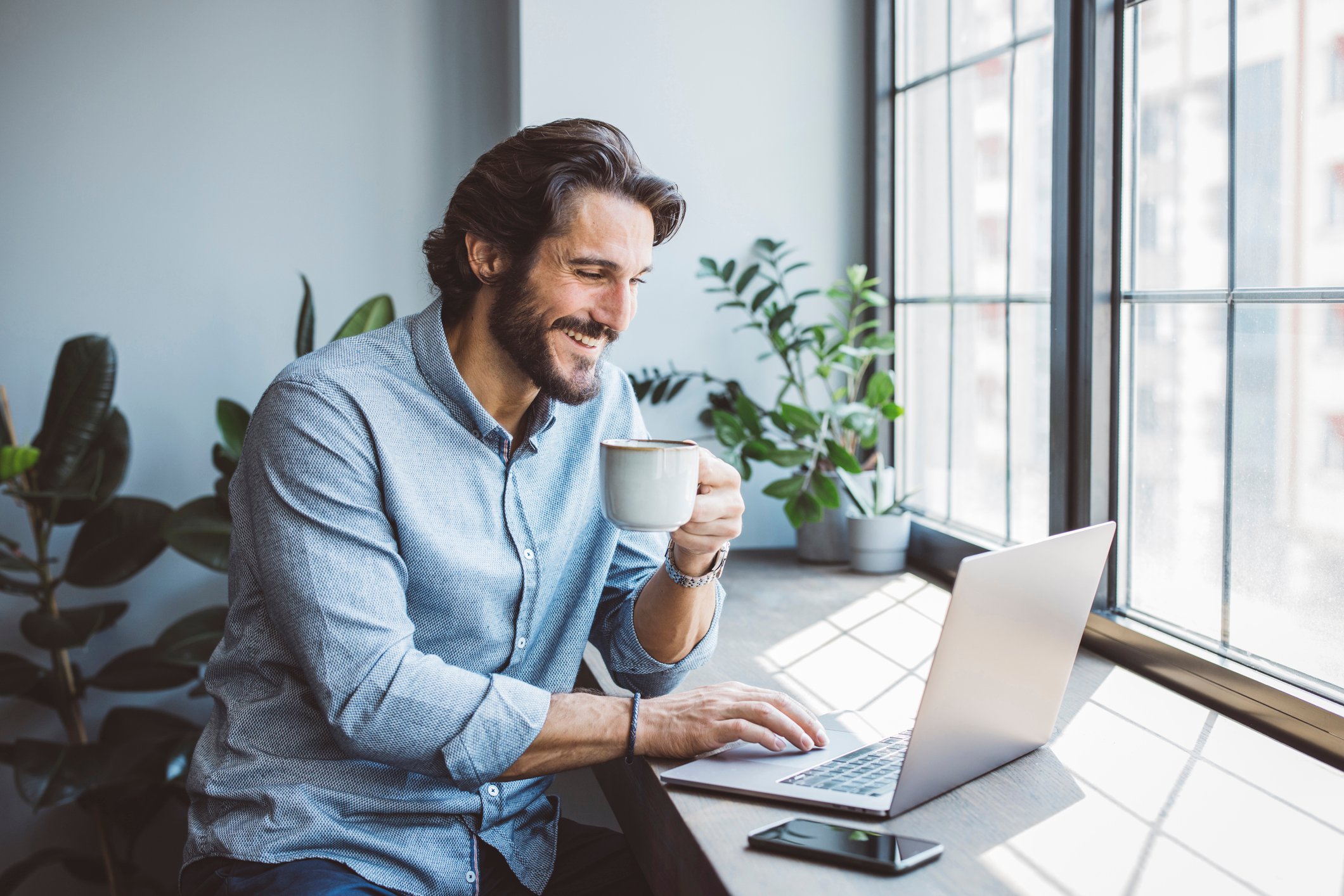 Crypto investor checks price Bitcoin investment on laptop at home.