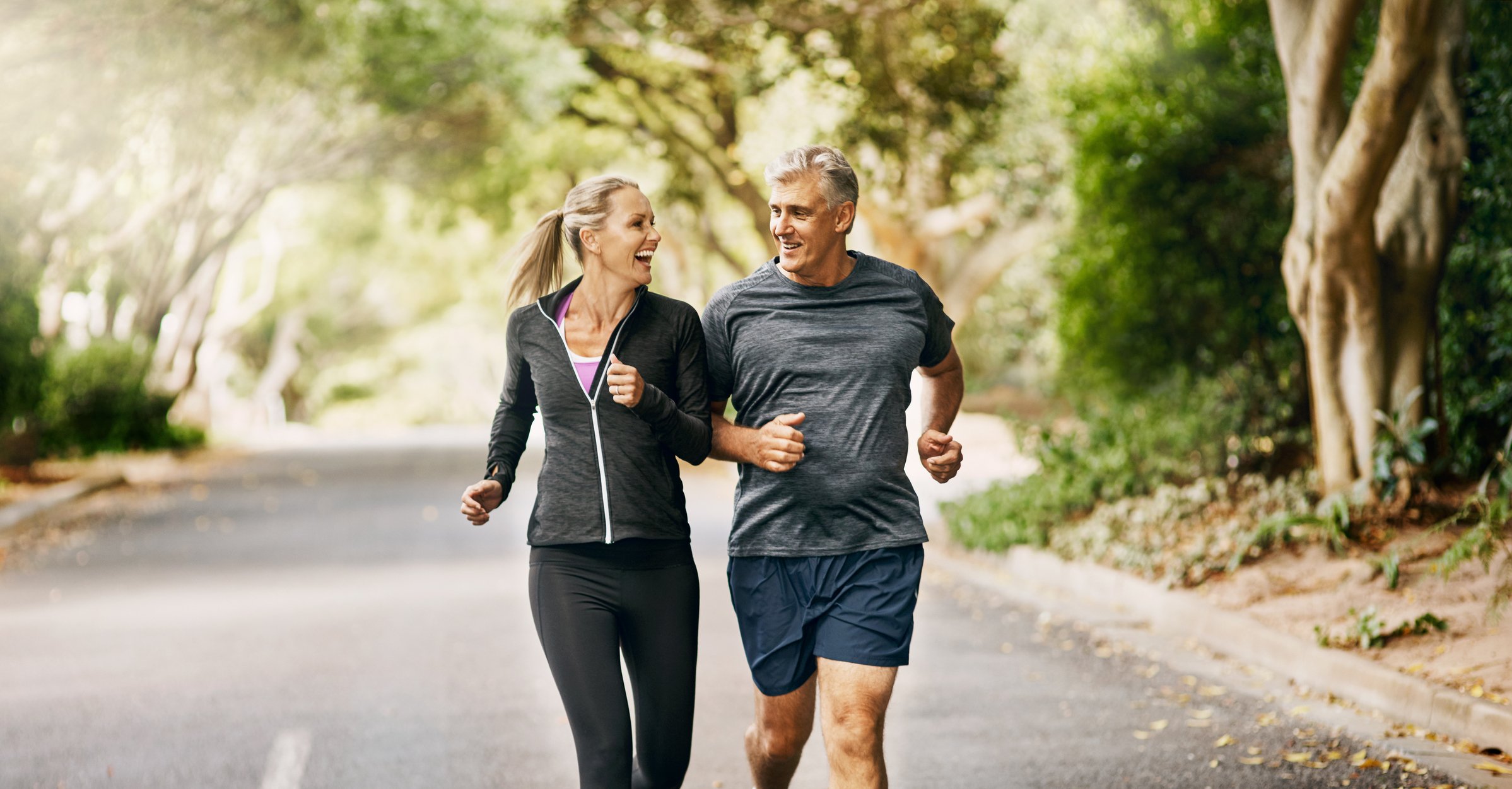 a mature couple out jogging on a sunny day
