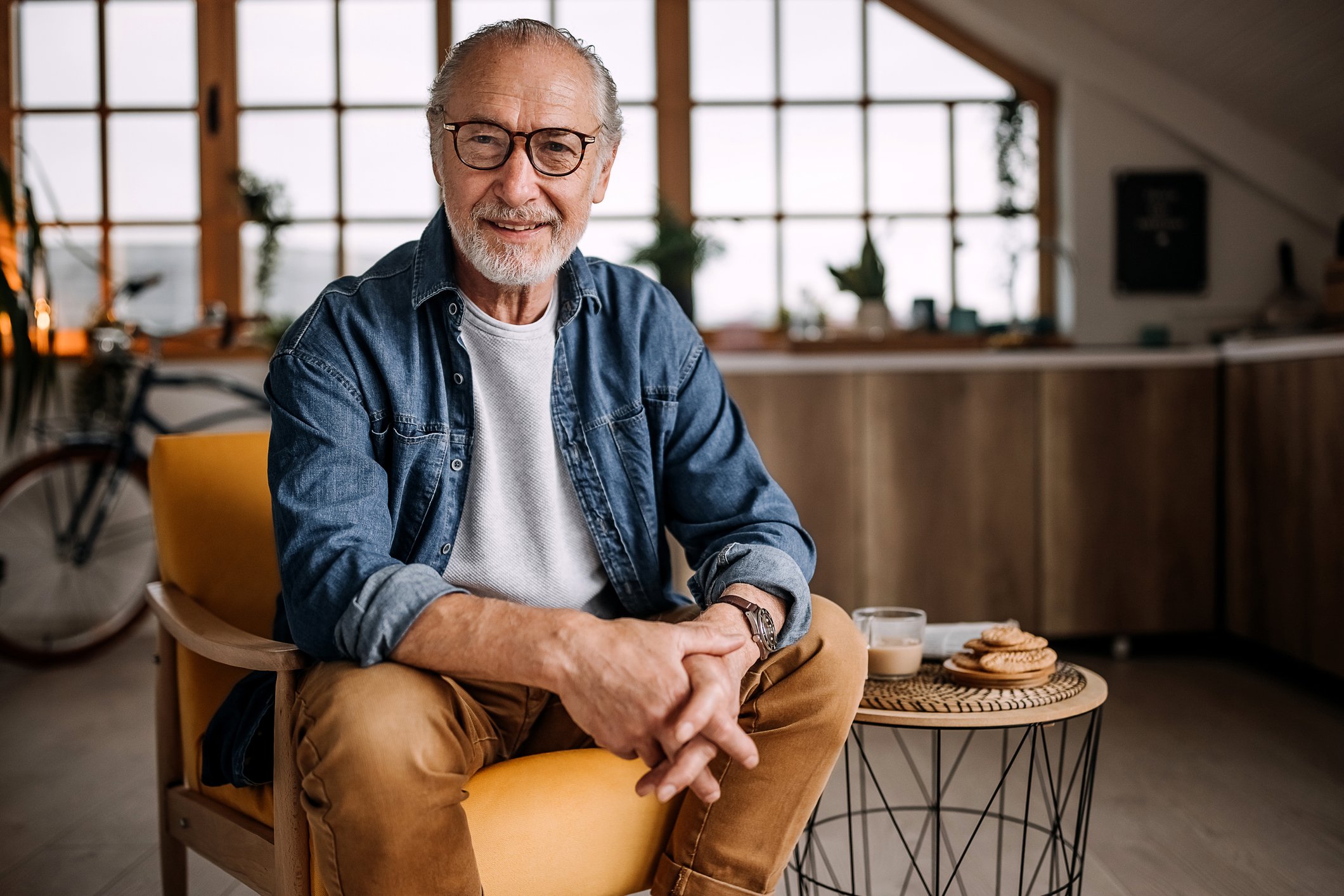 Portrait of senior man sitting on chair.