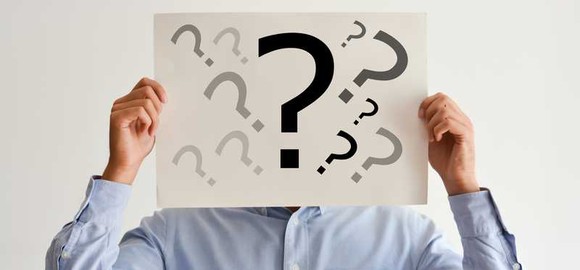 anonymous man holds question mark sign 