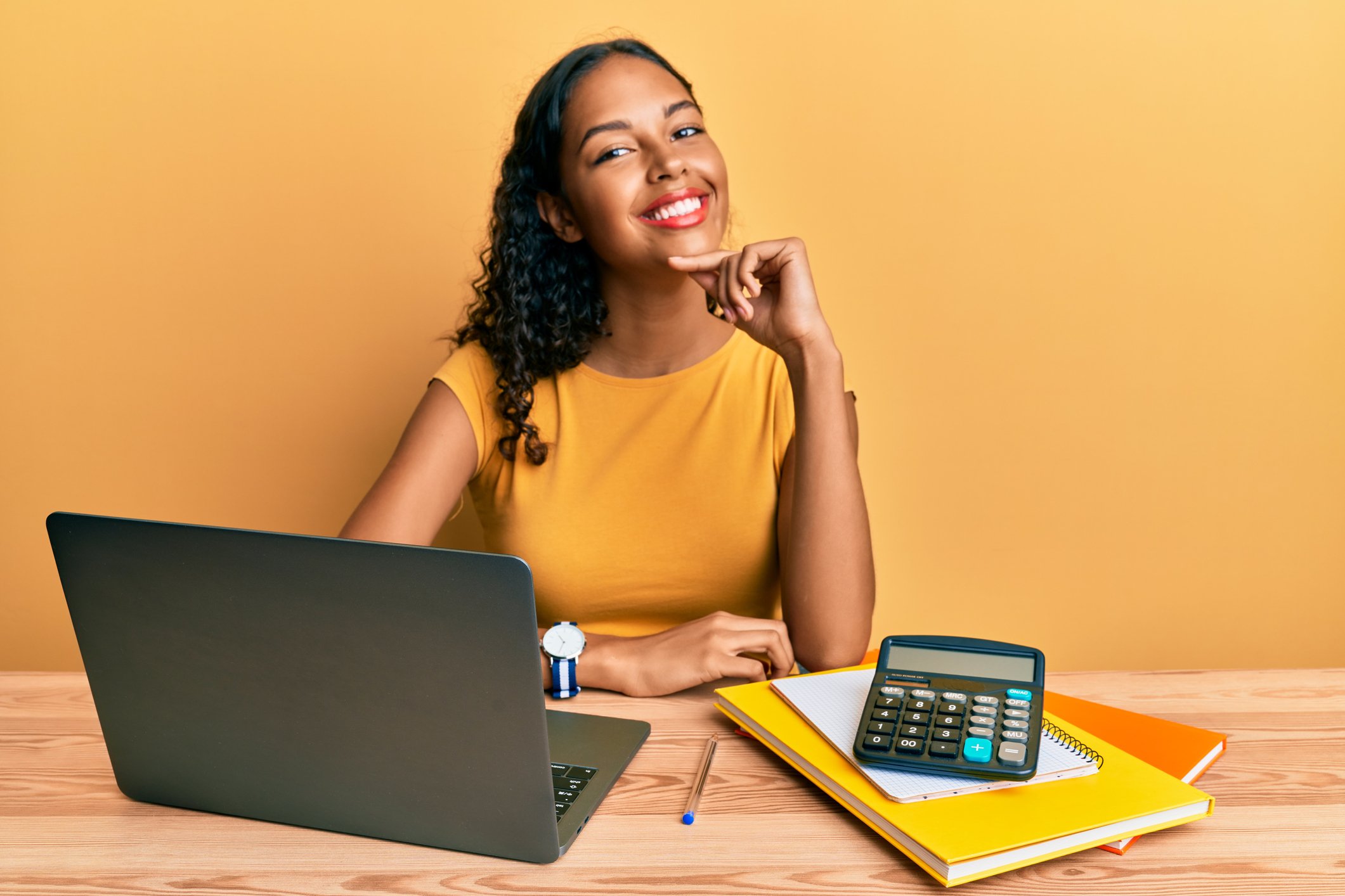 Happy investor with laptop and calculator